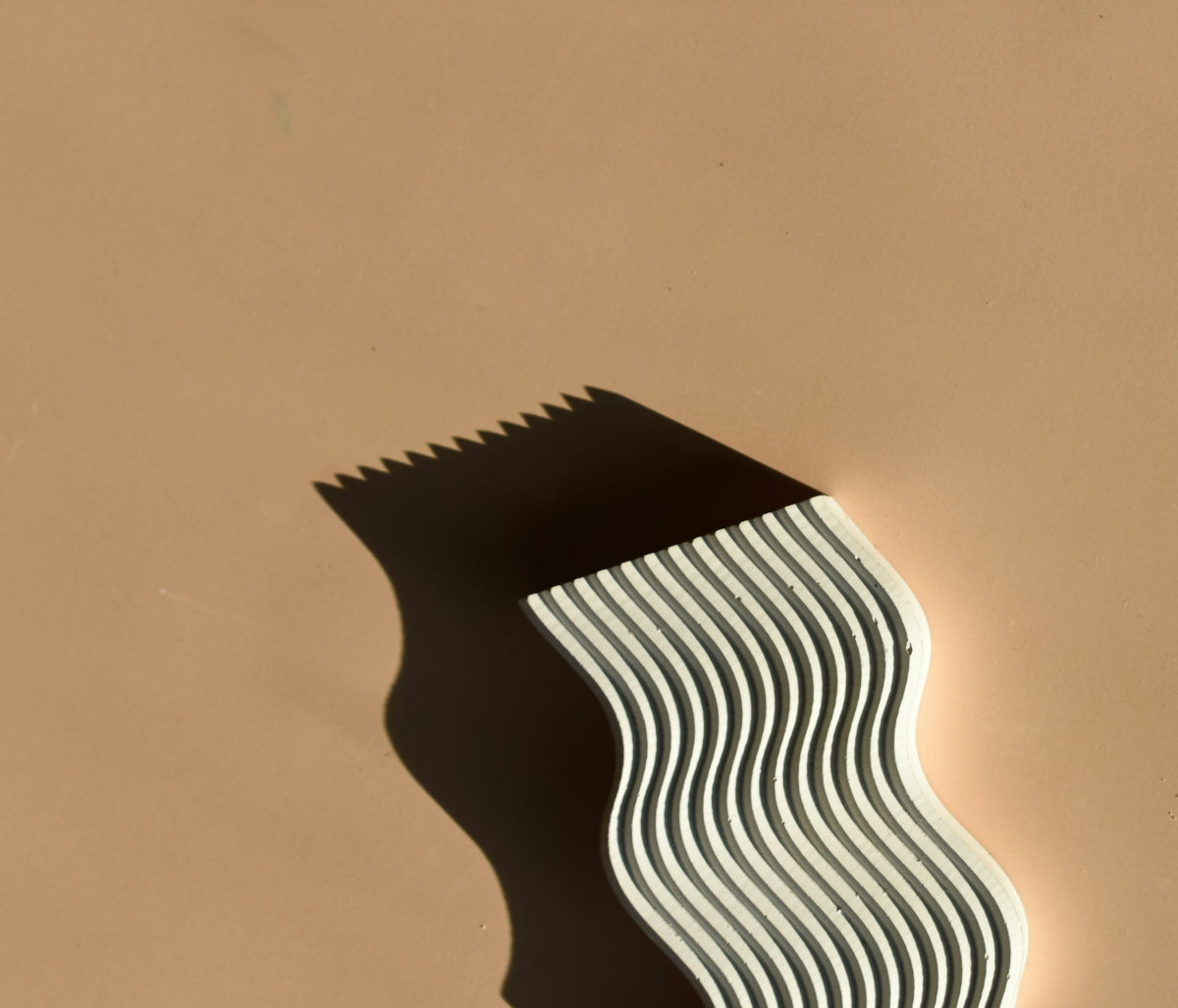 the shadow of a toothbrush on a wall