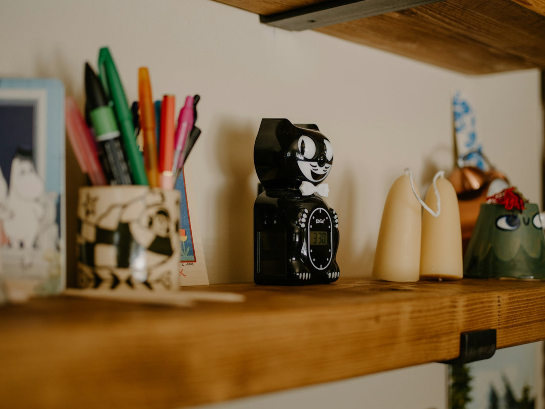 Various decorative items on a wooden shelf.